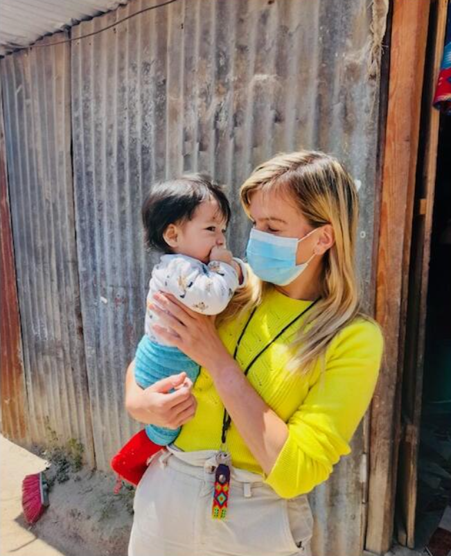Medical volunteer holding a child patient in Guatemala