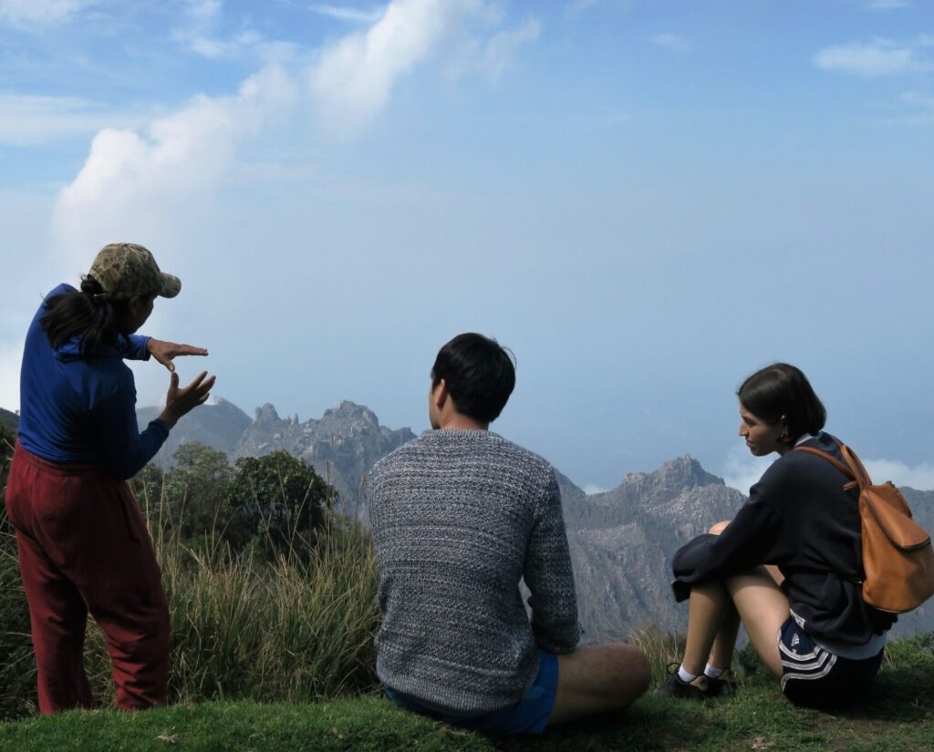 Local Guatemalan man speaking with tourists on a mountain view