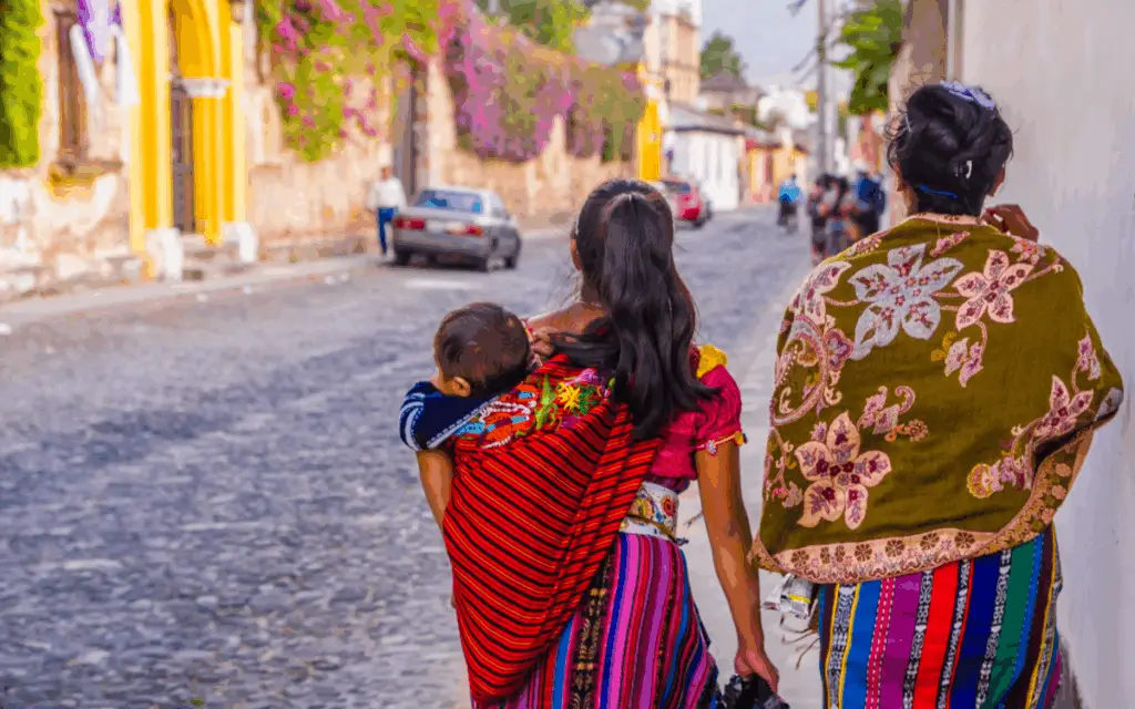 Local women brightly dressed, walking down the street in Guatemala