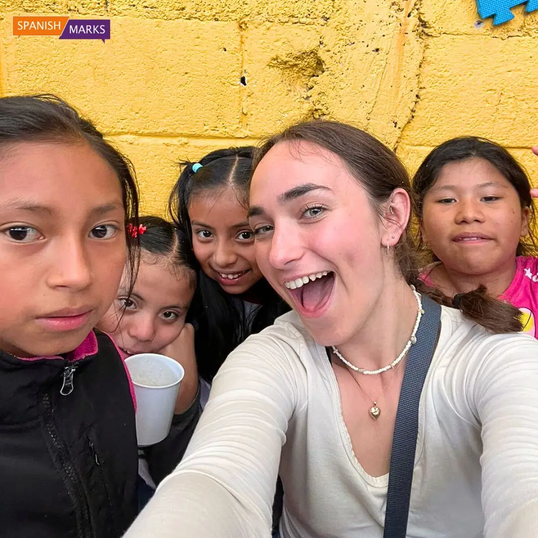 Teacher volunteer smiling with school childreni n Guatemala