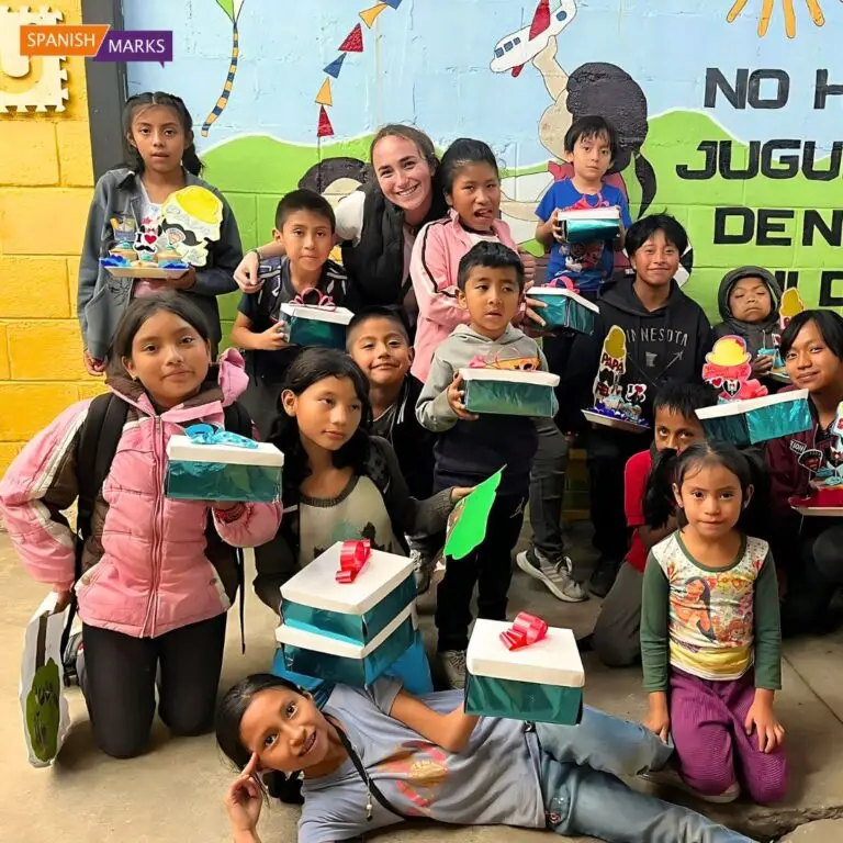 Teaching volunteer smiling surrounded by children in Guatemala