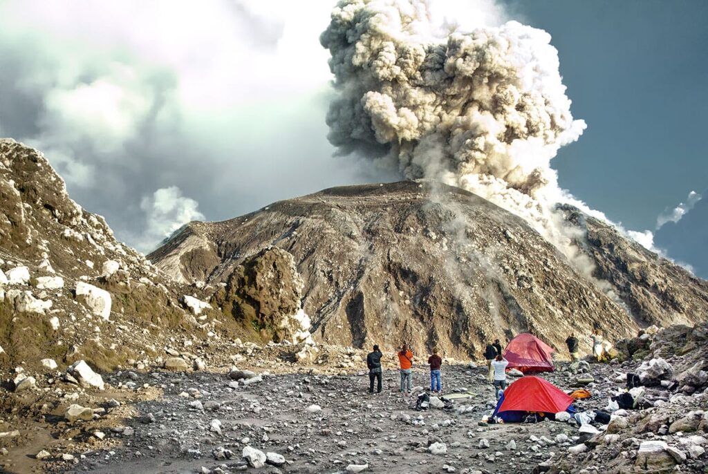 volcano santiaguito in Guatemala erupting with people watching